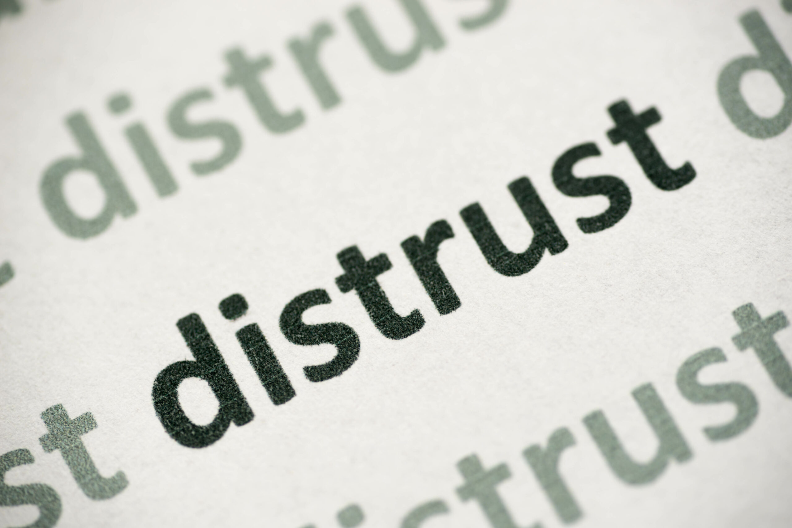 word-distrust-printed-on-paper-macro-trans-biz